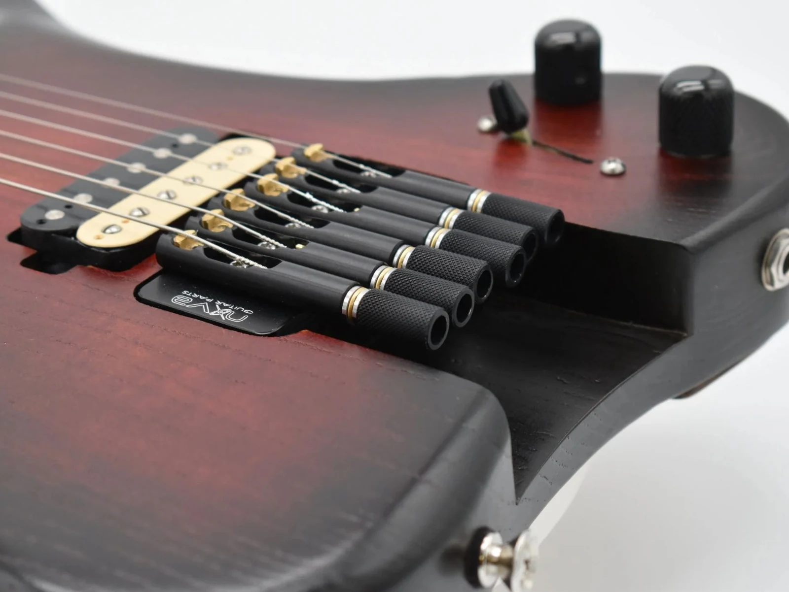 Anesidora guitar body with flush-mounted string hardware and custom pickups